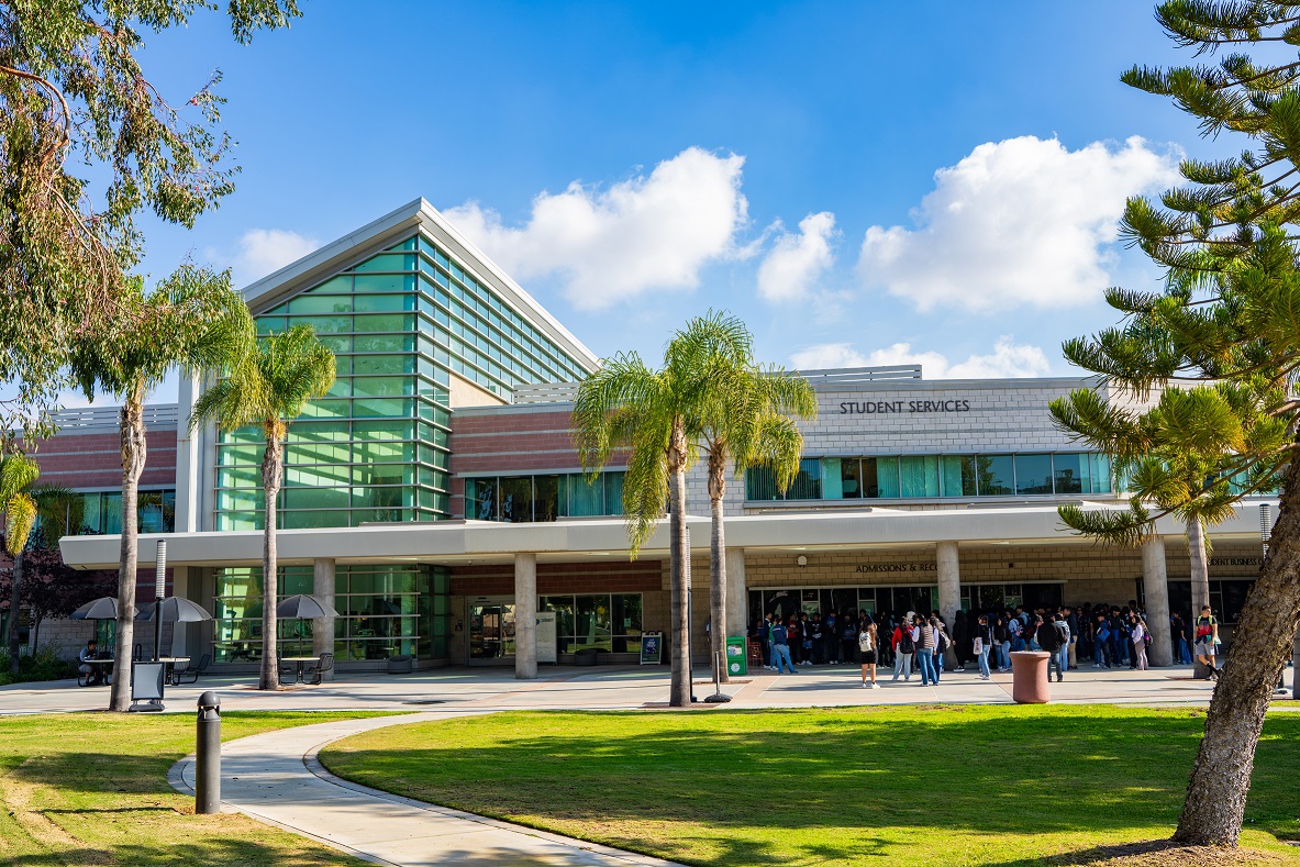 Front of the Student Services Building. Students are milling about outside of it.