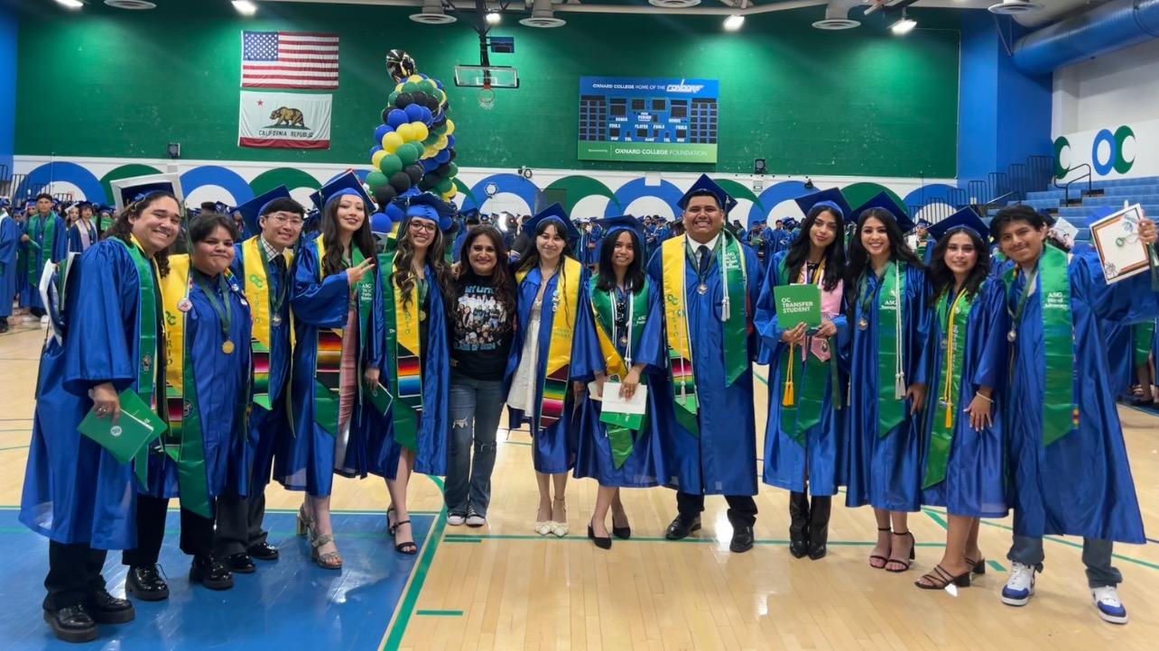 Class of 2024 students posing with ASG Advisor, Amparo Medina on graduation day.