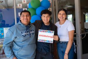 students with #HSIBelong sign